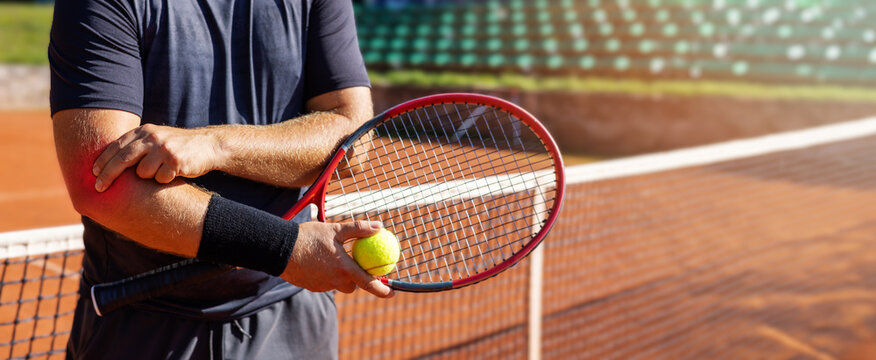 tennis elbow. male player with pain in his elbow joint. hand joint inflammation. sport injury. banner with copy space