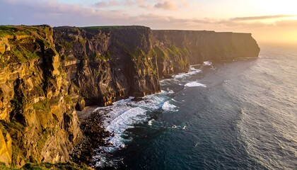 Dramatic cliffs meet the ocean at sunset