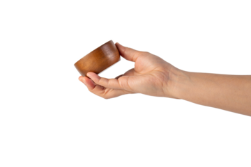 Small round wooden cup in hand on transparent background