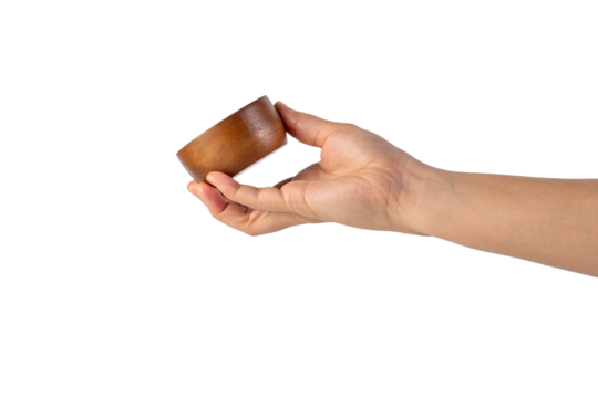 Small round wooden cup in hand on transparent background