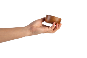 Small round wooden cup in hand on transparent background