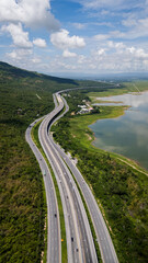 Fototapeta premium Drone shot The M6 motorway Nakhon Ratchasima Province - Bang Pa-in Lam Ta Khong River and Mountain. Motorway Korat Thailand