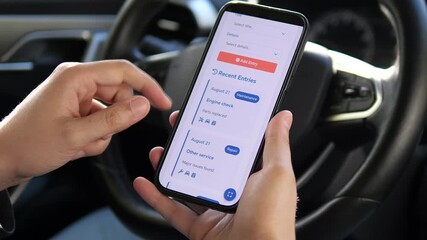A car owner's hands thoughtfully review past service entries in a vehicle maintenance app, rubbing fingers together while assessing the history. Perfect for content about automotive care, planning