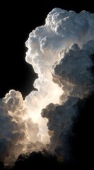 Dramatic vertical view of a thunderous cloud formation with a central bright light, against a black background, creates a feeling of awe and power