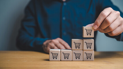 Online shopping growth strategy concept with wooden blocks and shopping cart icons for e commerce sales