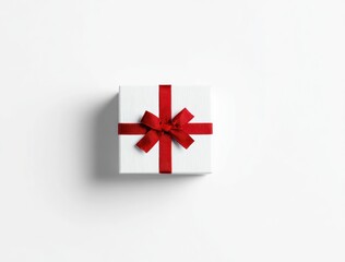 A white, square gift box tied with a bright red ribbon and bow is centered against a plain white background, casting a soft shadow