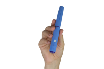 Close-up of a woman’s hand holding a syringe-shaped pen, isolated on white background, useful for advertising, education, or design projects.
