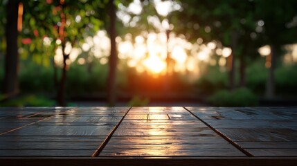 Wet wood planks overlook a blurred green garden at sunset. Sunlight filters through the trees creating a warm, inviting atmosphere