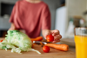 Happy young woman  having fun preparing healthy lunch food chopping vegetable  in kitchen