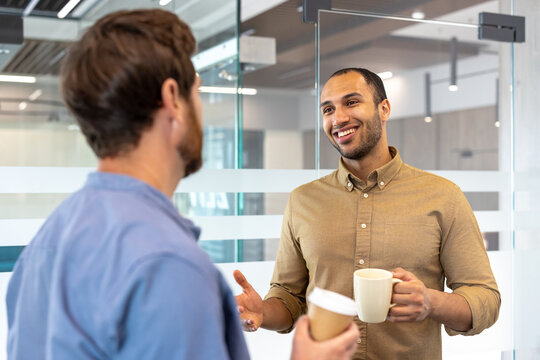 Colleagues engaging in friendly office conversation