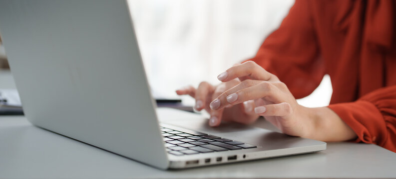 Freelancer working from home typing on laptop keyboard - Powered by Adobe