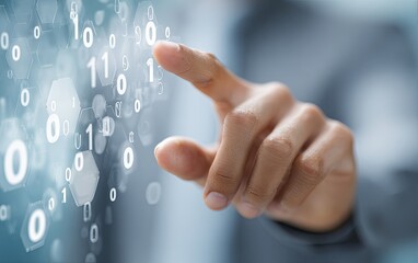 Close-up of a hand interacting with a digital display of binary code