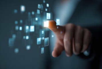 A person's finger points at a bright, glowing, blue square, amongst a pattern of similar, blurry shapes, against a blurred, dark backdrop