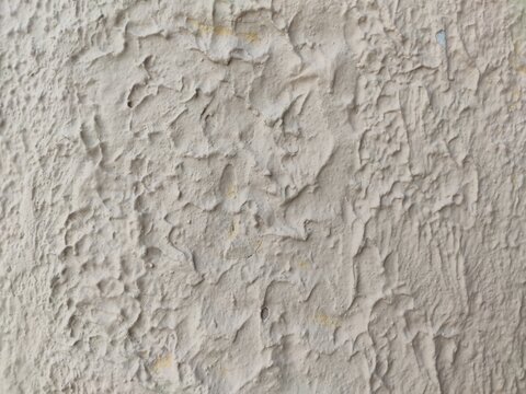 A rough popcorn ceiling with a bumpy, textured white finish, an abstract background for construction visuals or minimalist design projects.