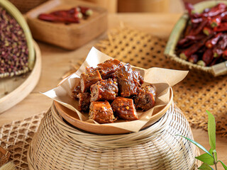 Pickled spicy duck neck wrapped in oil paper