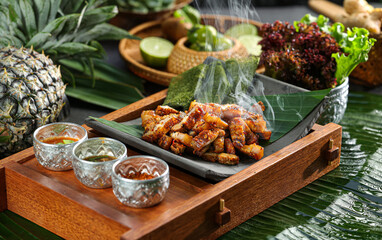 Grilled pork chunks wrapped in leaves with seasoning,the Dai nationality cuisine,from Xishuangbanna,Yunnan,China