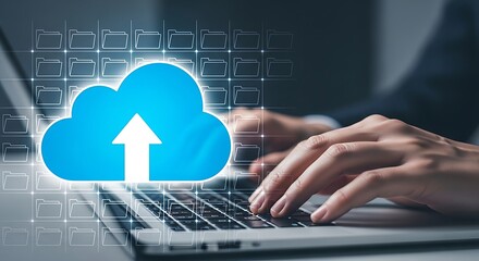 Digital cloud computing concept with a glowing blue cloud icon and an upward arrow overlaying a person s hands typing on a laptop keyboard representing data upload and storage