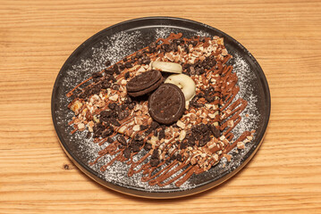 Wholemeal chocolate crepes filled with cocoa-infused ricotta and cooked pear pieces, decorated with crunchy almonds and honey