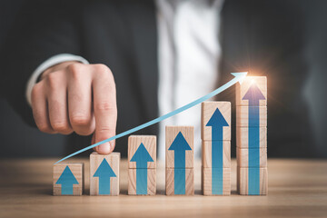 Business growth strategy concept with wooden blocks and arrows for financial success and development