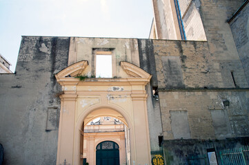 Religious complex of Santa Clara (Saint Clare) with basilica, monastery, tombs and museum.
Lateral brickwork fa&ccedil;ade of the basilica with the entrance of the cloister, Naples, Italy.
