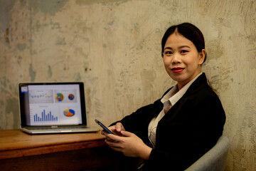 Professional businesswoman working at office desk with laptop, analyzing financial data, showcasing leadership, motivation, corporate expertise, and entrepreneurial confidence.