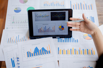 Organized stack of business documents and paperwork on office desk, representing planning, financial analysis, management, efficiency, responsibility, and deadline-focused professionalism.
