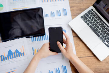 Confident businesswoman working at desk with computer in office, smiling while focusing on tasks, symbolizing success, motivation, persistence, and professionalism.
