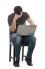 Disappointed man seated with laptop on knees, hand to forehead looking down upset. Stressed freelancer or programmer guy, mess in head, anxiety and headache feeling, isolated full length portrait
