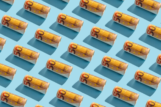 Fifty euro notes arranged in a seamless pattern on blue background