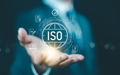 Obraz premium ISO certification concept. businessman holding digital globe and compliance icons, symbolizing international standards, quality assurance, auditing, and global business certification process.