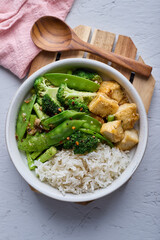 Stir-fried broccoli, peas, asparagus, and tofu over rice.