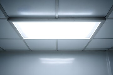Bright ceiling light panel in modern interior space.