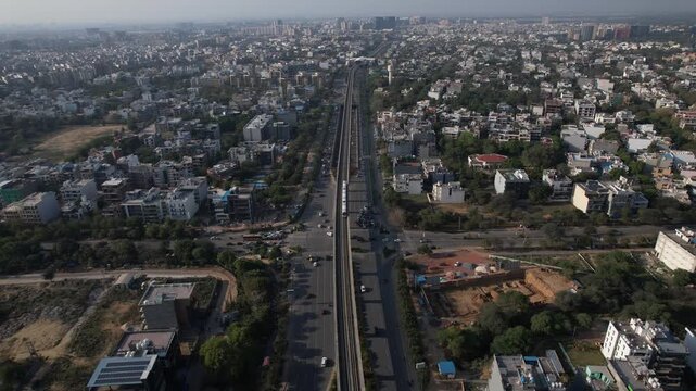 Aerial Drone Footage of Gurgaon Gurugram Buildings skyline Rapid Metro Road Cars traffic in gurgaon city Haryana Delhi NCR
