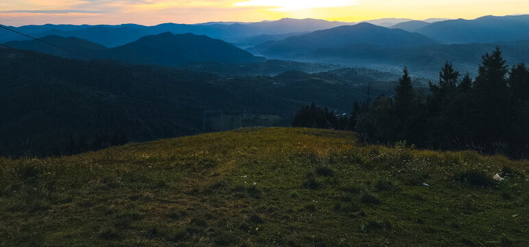 A peaceful twilight view of layered mountain ranges with dense pine forests, ideal for travel ads, wellness campaigns, and nature-inspired branding - Powered by Adobe