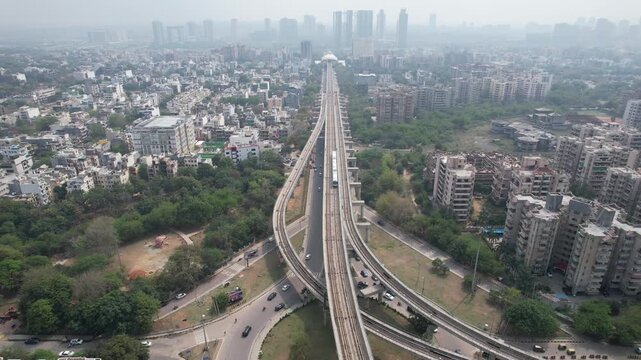Aerial Drone Footage of Gurgaon Gurugram Buildings skyline Rapid Metro Road Cars traffic in gurgaon city Haryana Delhi NCR