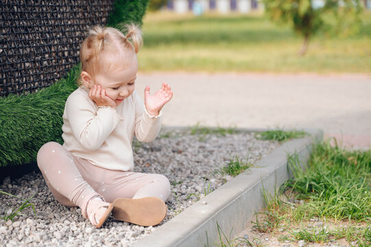 An adorable one and a half year old girl enjoying her time in a vibrant park