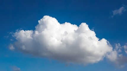 Bright White Cumulus Cloud Against a Vibrant Blue Sky: Fluffy Cumulus Cloud in Vivid Blue Sky, Crisp Sky Scene with Luminous White Cloud&mdash;Serene Nature View of Cumulus in Bold Blue Sky