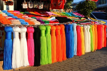 Colorful tassels and fabrics on a street market stall