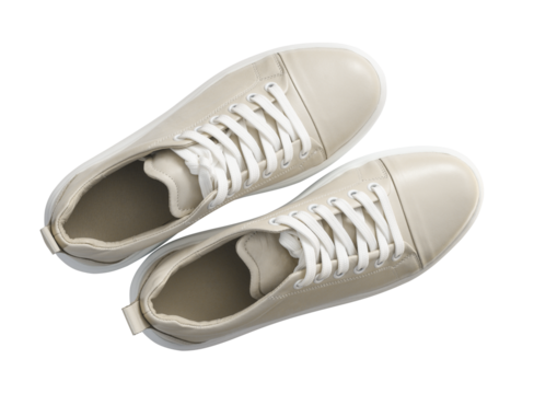 Pair of casual leather beige sneakers isolated on white or transparent background. Top view.