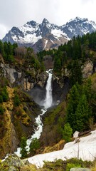 Majestic waterfall cascading down mountain valley