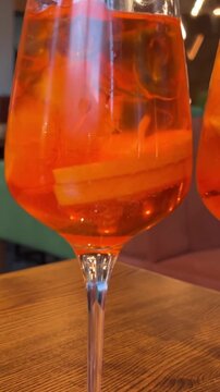 wooden table desserts Coco and Rose jelly cheesecake and two glasses of Aperol