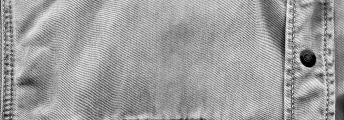 Stitched light black denim cotton shirt, pocket and button detail, jeans fabric texture background