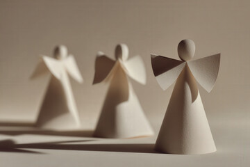 minimalist composition of paper nativity figures featuring delicate angels on clean ultrabright background