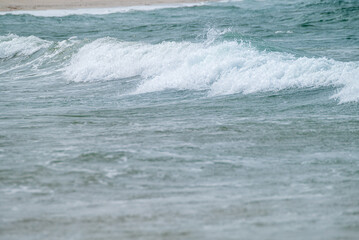 A close up of a small ocean wave breaking on the shore The Serene Beauty of Nature