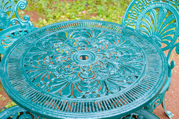 An ornate and vintage cast iron garden table and chair The Charm of a Vintage Style