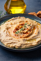 A traditional dish or appetizer hummus or baba ghanoush on black  background