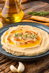 A traditional dish or appetizer hummus or baba ghanoush on wooden  background