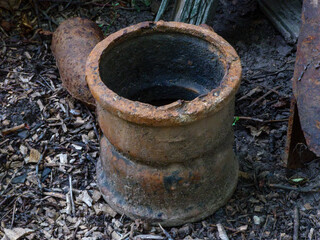 Abandoned Rusty Pipe on Forest Floor