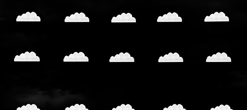 Repeating pattern of white clouds against a black background