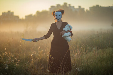 Creepy mysterious character wearing mask and gasmask in fog